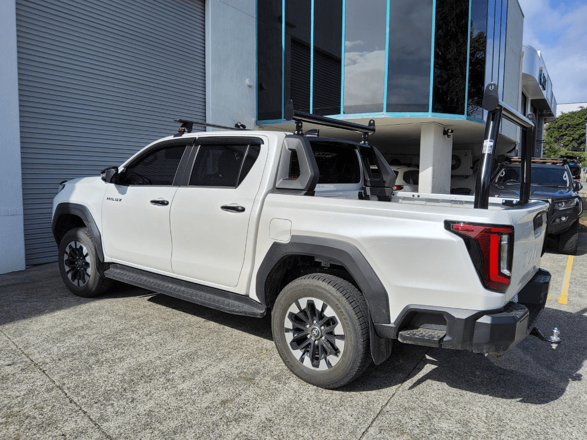 Toyota HiLux with AllBars black trade racks at the Brisbane workshop